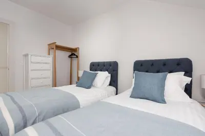 two beds sitting next to each other in a bedroom at Watersend in Porth