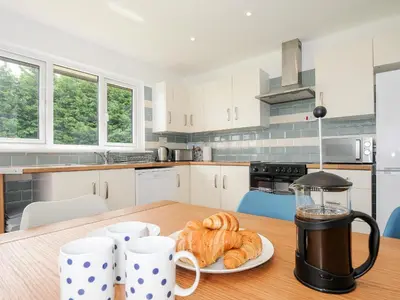 a kitchen with a table with a plate of croissants at The Old Forge in Saltash