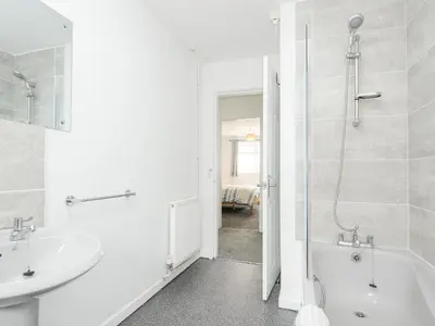 a bathroom with a tub and a sink and a bath tub at The Old Forge in Saltash