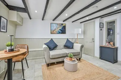 a living room with a couch and a table at Luxury Couple's Getaway with River Views and Parking in Polperro