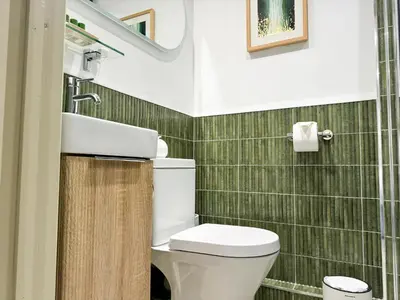 a bathroom with a toilet and a sink at Luxury Couple's Getaway with River Views and Parking in Polperro