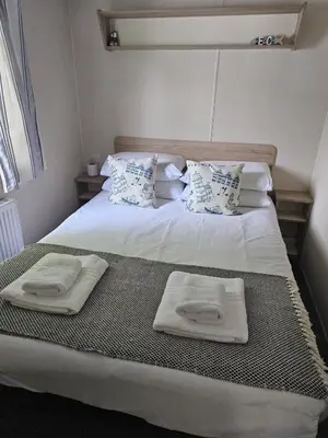 a bedroom with two beds with towels on them at Cornish Crantock Holiday Sandy Toes in Crantock