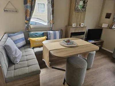 a living room with a couch and a table at Cornish Crantock Holiday Sandy Toes in Crantock