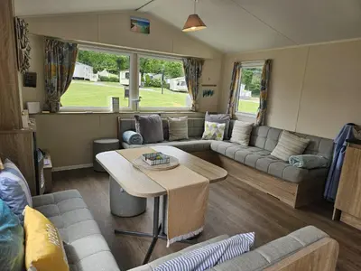 a living room with a couch and a table at Cornish Crantock Holiday Sandy Toes in Crantock