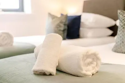 a white towel laying on top of a bed at 2 Bed in Newquay oc-e26943 in Newquay