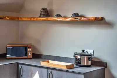 a kitchen counter with a microwave and a toaster oven at Finest Retreats - Beach House in Newquay