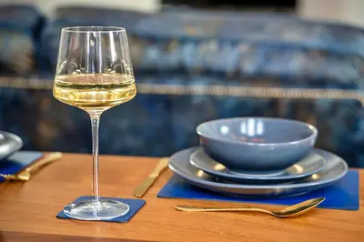 a glass of white wine sitting on a table at Finest Retreats - Beach House in Newquay