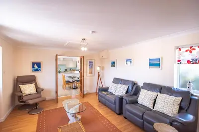 a living room with a couch and a chair at Mermaid - Pet Friendly Self Catering Holiday Cottage Hayle in Hayle