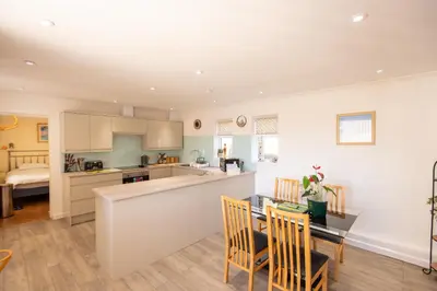 a kitchen and dining room with a table and chairs at Mermaid - Pet Friendly Self Catering Holiday Cottage Hayle in Hayle