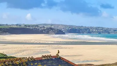 a group of people standing on the beach at Dolphin - Pet Friendly Self Catering Holiday Cottage Hayle St Ives Bay in Hayle