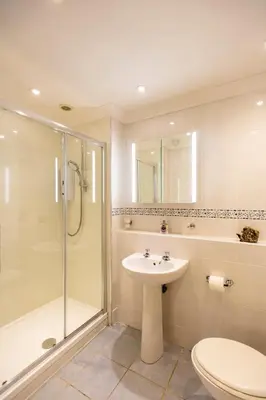 a bathroom with a shower toilet and a sink at Dolphin - Pet Friendly Self Catering Holiday Cottage Hayle St Ives Bay in Hayle