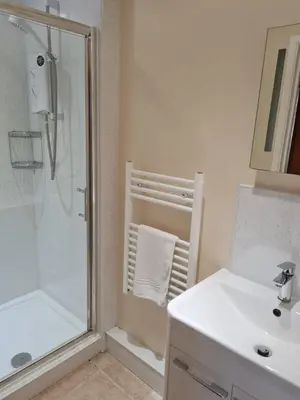 a bathroom with a shower and a sink at Dolphin - Pet Friendly Self Catering Holiday Cottage Hayle St Ives Bay in Hayle