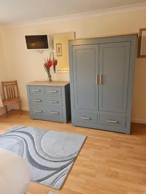 a bedroom with a dresser and a gray cabinet at Dolphin - Pet Friendly Self Catering Holiday Cottage Hayle St Ives Bay in Hayle