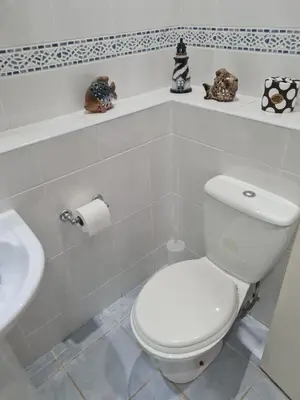 a bathroom with a white toilet and a sink at Dolphin - Pet Friendly Self Catering Holiday Cottage Hayle St Ives Bay in Hayle
