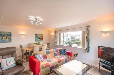 a living room with a couch and a table at Dolphin - Pet Friendly Self Catering Holiday Cottage Hayle St Ives Bay in Hayle