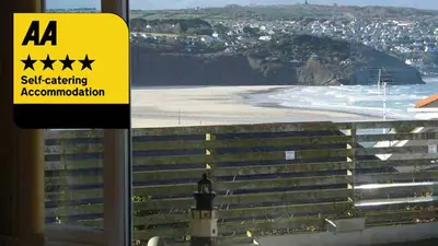 a sign on a window looking at a beach at Dolphin - Pet Friendly Self Catering Holiday Cottage Hayle St Ives Bay in Hayle
