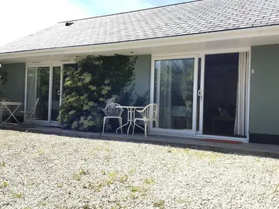 a screened in porch with a table and chairs at Wadebridge Whitecross Studio 2 in Wadebridge
