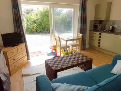 a living room with a blue couch and a table at Wadebridge Whitecross Studio 2 in Wadebridge