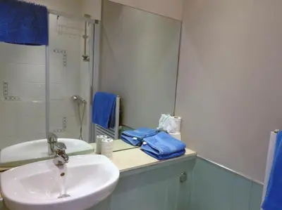a bathroom with a sink and a mirror at Wadebridge Whitecross Studio 2 in Wadebridge