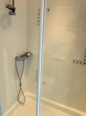 a shower with a shower head in a bathroom at Wadebridge Whitecross Studio 2 in Wadebridge