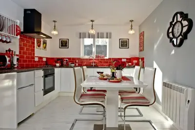 a kitchen with a white table and chairs at Hill Head Cottage in Saint Columb Major