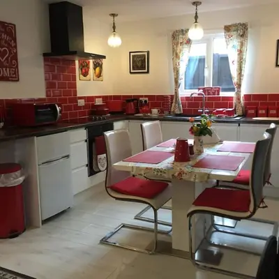 a kitchen with a table and chairs in a kitchen at Hill Head Cottage in Saint Columb Major