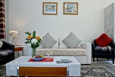 a living room with a white couch and a table at Hill Head Cottage in Saint Columb Major