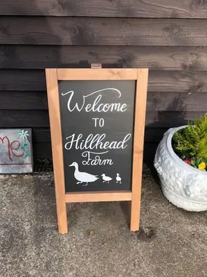 a sign that says welcome to highhead station in front of a house at Hill Head Cottage in Saint Columb Major