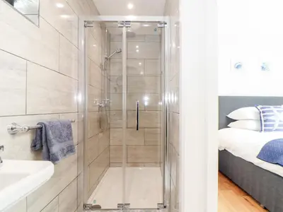 a shower with a glass door in a bathroom at Chi an Mor in Penzance