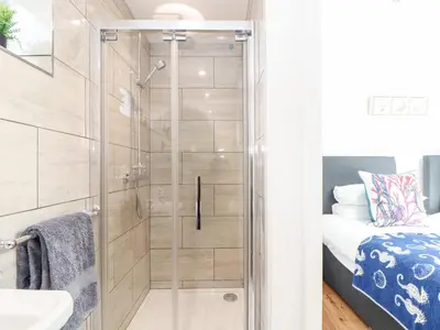 a shower with a glass door in a bathroom at Chi an Mor in Penzance