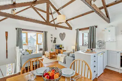 a kitchen and living room with a table and chairs at 2 Bed in Looe oc-b27563 in Looe