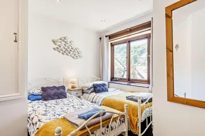 a bedroom with two beds and a window at 2 Bed in Looe oc-b27563 in Looe