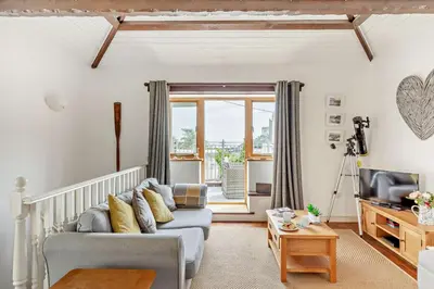 a living room with a couch and a tv at 2 Bed in Looe oc-b27563 in Looe