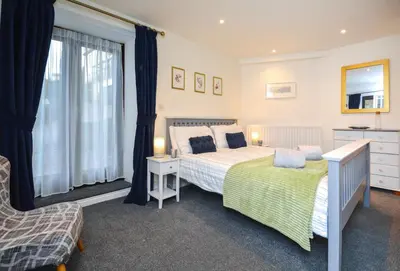 a bedroom with two beds and a window at 2 Bed in Looe oc-b27563 in Looe