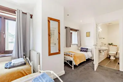 a bedroom with two beds and a bathroom at 2 Bed in Looe oc-b27563 in Looe