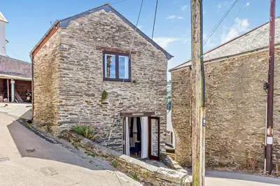 a brick building with a window on the side of it at 2 Bed in Looe oc-b27563 in Looe