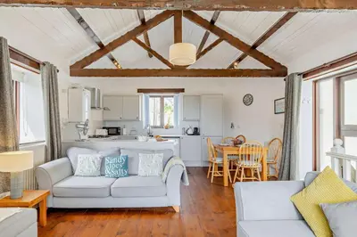 a living room with two couches and a kitchen at 2 Bed in Looe oc-b27563 in Looe
