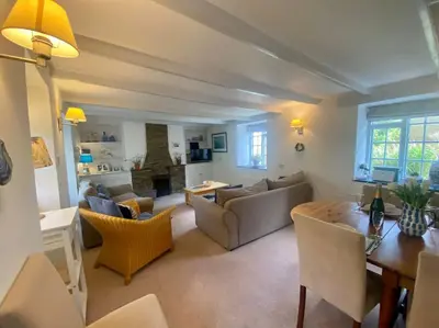 a living room with a couch and a table at Brook Cottage is a traditional fisherman's cottage in Port Isaac