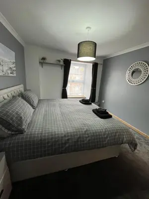 a bedroom with a bed and a window at Pet friendly cottage in Pool