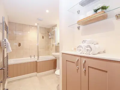 a bathroom with a sink and a toilet and a shower at Potters Barn in Helston