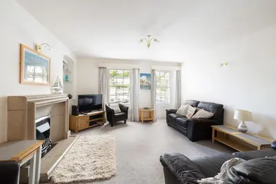 a living room with a couch and a fireplace at Quayview in Looe