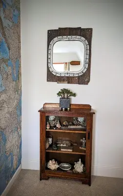 a dressing table with a mirror on a wall at Treheveras Guest House in Newquay