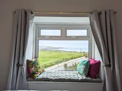 a window seat with a view of a field at Treheveras Guest House in Newquay