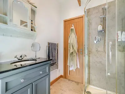 a bathroom with a blue sink and a shower at Myrtle Cottage in Saint Just in Roseland