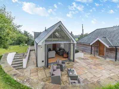 an extension to a house with a patio at Myrtle Cottage in Saint Just in Roseland