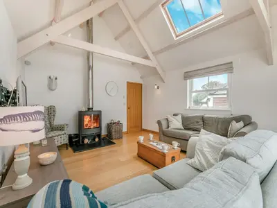 a living room with a couch and a fireplace at Myrtle Cottage in Saint Just in Roseland