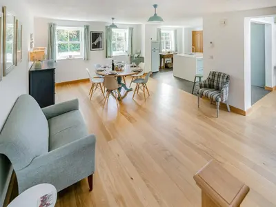 a living room with a couch and a table at Myrtle Cottage in Saint Just in Roseland