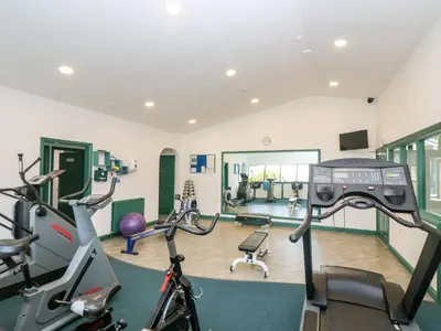 a gym with cardio machines and exercise bikes at Albert's Den in Falmouth
