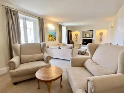a living room with two couches and a table at Coswarth Cottage in Padstow