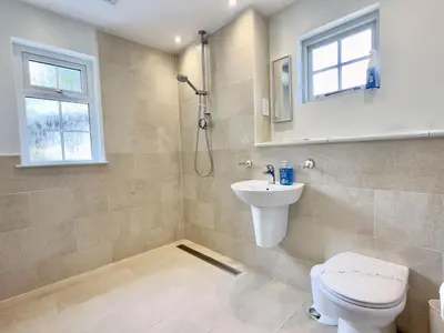 a bathroom with a toilet and a sink and a shower at Coswarth Cottage in Padstow